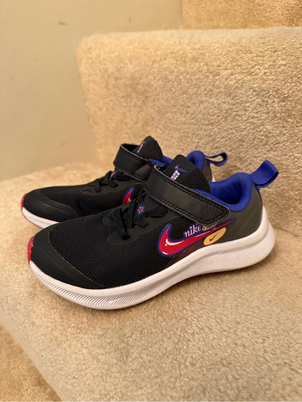 Nike Black Kids' Sneakers with Purple Lining and Red Accent